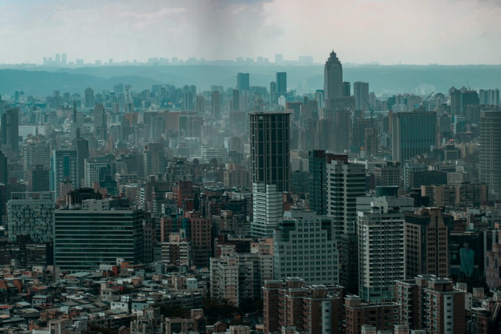 A dramatic aerial photograph showcasing a dense urban cityscape under a layer of smog.